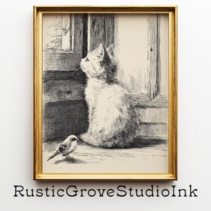 May include: A framed black and white print featuring a detailed illustration of a fluffy cat gazing out a window, with a small bird perched nearby. The artwork is in a gold frame and is signed "RusticGroveStudioInk".