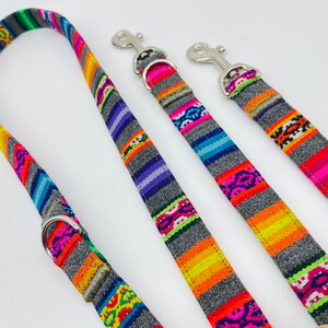 May include: Three colorful dog leashes with grey backgrounds and silver clips. The leashes have a woven pattern with bright colors like pink, orange, yellow, green, and blue.