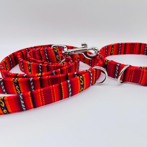 May include: Red and yellow striped dog collar and leash set with a silver clasp.