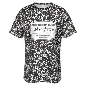May include: A short-sleeve t-shirt featuring a black and white speckled pattern resembling a composition notebook cover. A central white label displays the text COMPOSITION BOOK, Mr Jose, 100 Sheets - 200 Pages, and College Ruled.