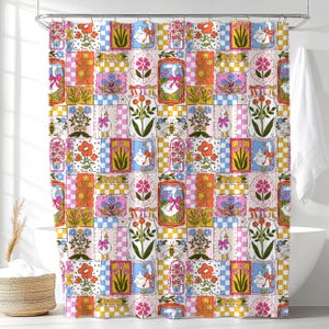 May include: A shower curtain featuring a repeating patchwork pattern of white geese wearing pink bows, colorful floral arrangements, bees, and checkered squares in shades of yellow, pink, blue, and orange on a light background with small dots.