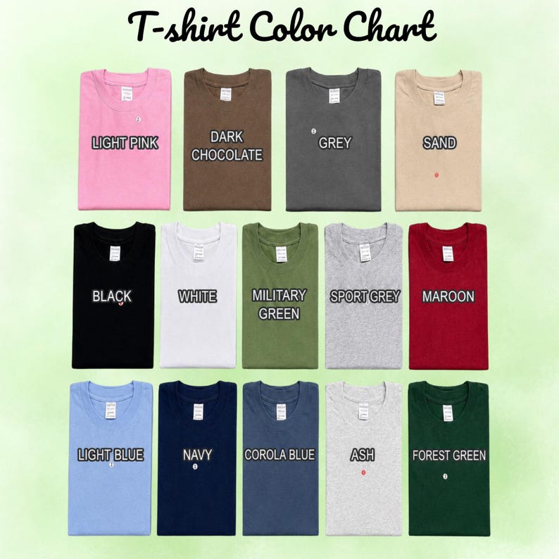 May include: A T-shirt Colour Chart displaying thirteen folded shirts in various colours including light pink, dark chocolate, grey, sand, black, white, military green, sport grey, maroon, light blue, navy, corola blue, ash, and forest green.