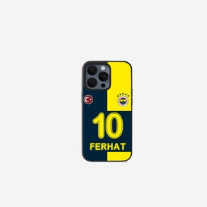May include: A navy blue and yellow phone case featuring the number 10 and the name FERHAT in yellow. The case has a Turkish flag and a team logo. The case is designed to fit a smartphone.