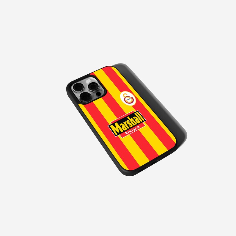 May include: Black phone case with a red and yellow striped design, featuring the text "Marshall boya" in a rectangular logo. The case also includes a circular emblem and a camera cutout.