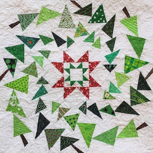May include: A white background with a red and green star in the centre surrounded by green and white triangle-shaped Christmas trees.