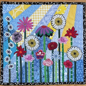 May include: A colourful patchwork quilt depicting a variety of flowers in a garden setting. The quilt is made with different fabrics and patterns, including blue, yellow, green, red, pink, and white. The flowers are arranged in a whimsical and abstract way, creating a cheerful and vibrant design.