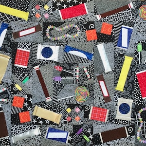 May include: A black and white quilt with various shapes and patterns, including circles, stars, and stripes. The quilt is made of fabric scraps and features a variety of colors, including red, blue, yellow, and green.