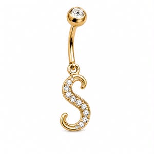 May include: A gold-toned belly button ring featuring a curved barbell with a single clear round gemstone at the top and a dangling letter S charm. The letter S is embellished with a series of small, clear, round gemstones along its front surface.