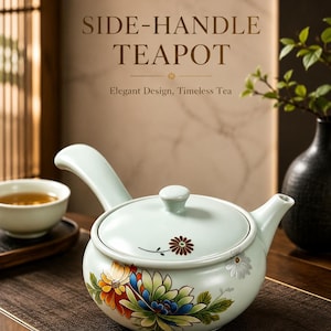 May include: A light blue side-handle teapot with floral designs in red, yellow, blue, and green. The teapot has a matching lid and a curved handle. The text "SIDE-HANDLE TEAPOT" and "Elegant Design, Timeless Tea" are visible.