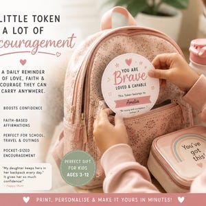 May include: A round white token with pink text reading YOU ARE BRAVE LOVED & CAPABLE and Amelia, featuring a heart icon. It is held against a floral pink backpack next to a small square case with a rainbow graphic and the text You've got this.