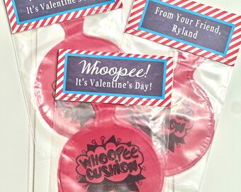 May include: Three red whoopie cushions in clear plastic bags with Valentine's Day themed tags. The tags have red and white stripes and say "Whoopee! It's Valentine's Day!" One tag says "From Your Friend, Ryland".