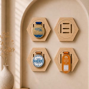 Puede incluir: Soportes hexagonales de madera con detalles grabados, mostrando medallas de maratón. Una medalla dice "SAUMUR 2024 MARATHON DE LA LOIRE", otra "MADRID MARATHON 2024", y una tercera "MARATHON POUR TOUS PARIS 2024". Montados en una pared beige.