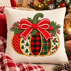May include: A square off-white throw pillow featuring an embroidered pumpkin design. The pumpkin is divided into segments with red polka dots, green pine trees, red and black buffalo plaid, and green tartan patterns, topped with a red bow.