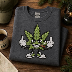 May include: A dark gray crewneck sweatshirt featuring an embroidered graphic of a green cannabis leaf character with an angry expression, white gloves giving the middle finger on both hands, and wearing green and white sneakers while smoking a cigar.