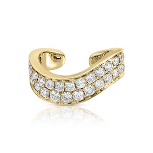 May include: A gold ear cuff featuring a curved, open-ended band design. The surface is adorned with two parallel rows of small, round, clear, faceted stones that catch the light, set against a polished, reflective yellow gold metal finish.