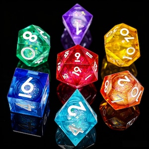 Può includere: Un set di dadi poliedrici traslucidi multicolori. I dadi sono in varie forme e colori, tra cui verde, viola, rosso, blu, giallo e arancione. Ogni dado ha numeri bianchi e glitter all'interno, perfetti per i giochi da tavolo.