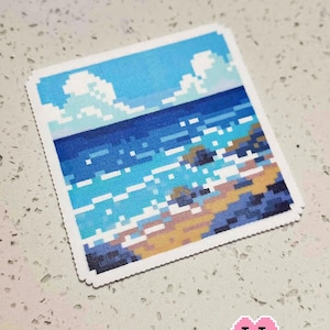 May include: A square pixel art image depicting a seascape with a blue sky, white clouds, and ocean waves. The text "Go see the sea with you" is at the top. The bottom right corner has the text "Puff Bead + Patterns".