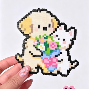 May include: Pixelated art piece featuring a puppy and a cat holding a bouquet of flowers. The puppy is beige and the cat is white, both outlined in black. The flowers are pink, blue, and green. Text at the top reads "Puppy Holding Flowers".