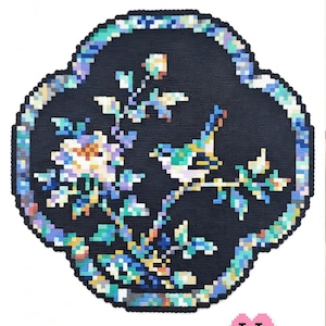 May include: A pixel art pattern titled Azure Bird on Blossoms Chinese Mother-of-Pearl Inlay Style by Puff Bead Patterns. The design features a bird perched on a flowering branch within a scalloped border, rendered in shades of blue, white, and teal.