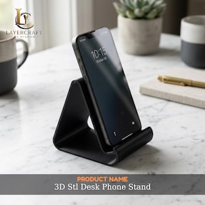 May include: A black 3D-printed desk phone stand supporting a smartphone. The phone shows the time and date. The stand has a triangular shape and is on a white marble surface. The product name is "3D Stl Desk Phone Stand."