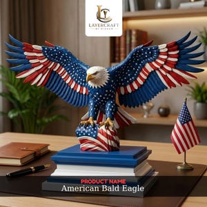 May include: A decorative sculpture of a bald eagle with wings spread wide, featuring a red, white, and blue star-spangled pattern. The eagle stands on a base shaped like a folded American flag, resting on a tiered blue and white rectangular pedestal.