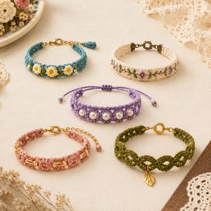 May include: Five handcrafted crochet bracelets featuring various designs: a blue band with yellow flowers, a cream band with purple floral embroidery, a purple band with white pearls, a pink band with gold beads, and an olive green band with a gold leaf charm.