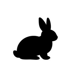 May include: A black silhouette of a rabbit in a seated position, with its ears upright. The rabbit is facing to the right against a white background. The image is a simple, graphic representation of a bunny.
