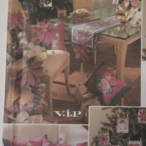 May include: A set of Christmas-themed pillows and ornaments featuring a poinsettia design. The pillows are made with a variety of fabrics, including red, green, and blue. The ornaments are made of felt and are decorated with a variety of embellishments, including buttons, beads, and ribbon.