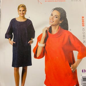 May include: Kwik Sew pattern K3928 for misses in sizes XS-XL. The envelope displays two garment options: a dark blue knee-length dress with three-quarter sleeves and side pockets, and an orange top with a cowl neckline and three-quarter sleeves.