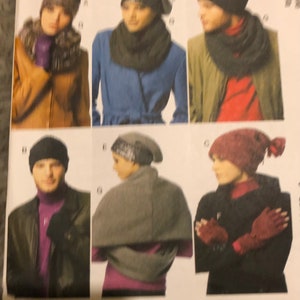 May include: Six different styles of hats and scarves, including a black beanie, a gray beanie, a red beanie, a black scarf, a gray scarf, and a red scarf.