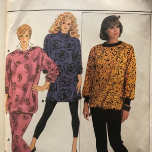 May include: A sewing pattern for a women's top and leggings. The pattern includes three different styles: a pink paisley top and leggings, a purple floral top and black leggings, and a yellow and black abstract print top and black leggings. The pattern is for sizes P-S-M.