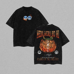 May include: Black t-shirts with a distressed wash. One shirt features two cartoon faces with flames, the other has the text "Mera Mera No Mi" above a fiery design. The text "Flames of the Fire Fist!" is also visible.