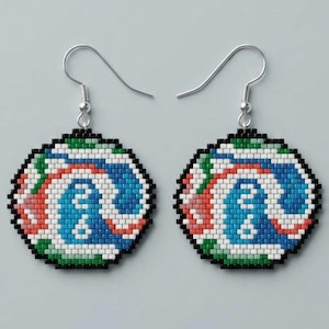 May include: A pair of circular drop earrings crafted from small, square beads. The design features a swirling pattern of white, blue, red, and green beads, all outlined in black. Each earring hangs from a silver-toned metal hook for attachment.