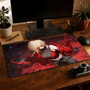 May include: A large rectangular mousepad featuring a detailed anime-style illustration. The artwork depicts a character in a red outfit with a weapon against a red and black background. The mousepad is on a wooden desk with a keyboard and monitor.