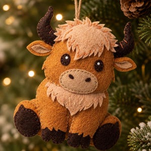 May include: A felt bull ornament in shades of brown, with dark brown horns and hooves. It features a light brown mane and a beige face. The ornament hangs from a natural twine string, ideal for festive decorations, and is approximately 15cm in height.