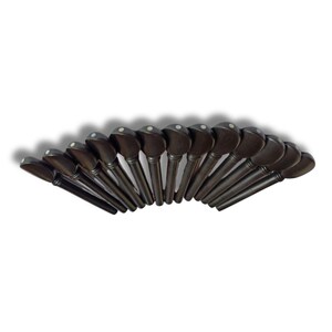 May include: A collection of dark brown violin pegs arranged in a semi-circle. Each peg has a rounded head with a small, white dot. The pegs are made of wood and are designed for tuning a violin.