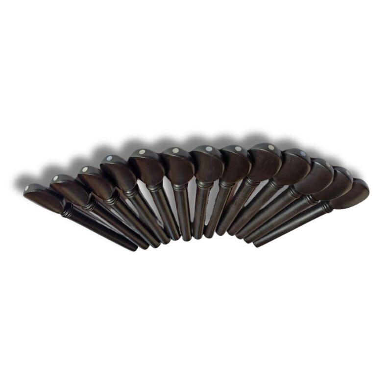 May include: A collection of dark brown violin pegs arranged in a semi-circle. Each peg has a rounded head with a small, white dot. The pegs are made of wood and are designed for tuning a violin.