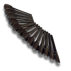 May include: A collection of dark brown violin pegs arranged in a curved pattern. Each peg has a rounded head with a small white dot and a tapered shaft. The pegs are set against a white background.