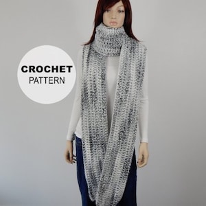 May include: A white and gray crochet scarf with a long, flowing design. The scarf is worn by a mannequin with long, dark hair. The text "CROCHET PATTERN" is visible in the image.