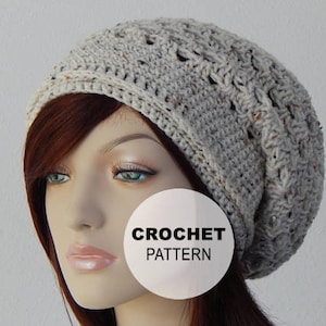 May include: A crocheted beanie hat in a light beige color with a textured pattern. The hat has a slouchy fit and is made with a soft yarn. The text "CROCHET PATTERN" is visible on a white circle.