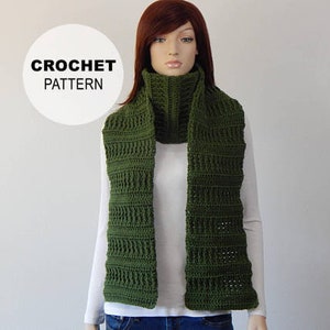 May include: A green crocheted scarf with a cowl neck. The scarf is made with a simple stitch pattern and is a great accessory for the fall and winter.