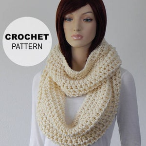 May include: A crocheted infinity scarf in a cream color. The scarf is made with a simple stitch pattern and is a great accessory for any outfit.
