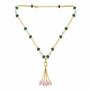 May include: A gold chain necklace featuring alternating green faceted beads and smooth light pink beads. The necklace includes a central gold oval link connected to four short gold chains, each ending in a single smooth light pink bead.