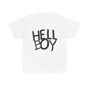 May include: White t-shirt with the words "HELL BOY" printed in black, handwritten-style lettering across the back. The shirt is made of a soft, comfortable material.
