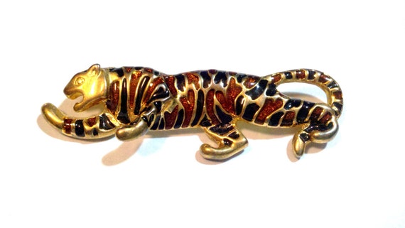 Enamel black and orange jaguar brooch with glitter accents.