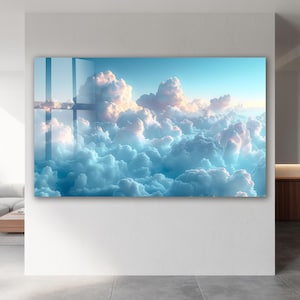 May include: A rectangular wall art piece depicting a serene sky filled with fluffy, light blue and white clouds. The clouds are illuminated with soft, golden sunlight, creating a calming and ethereal atmosphere. The artwork is mounted on a white wall.