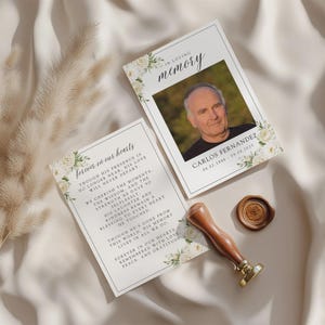 May include: Two memorial cards with floral accents and the text "In Loving Memory" and "Forever in Our Hearts." One card features a photo of Carlos Fernandez with dates. A wooden handled wax stamp is also present.