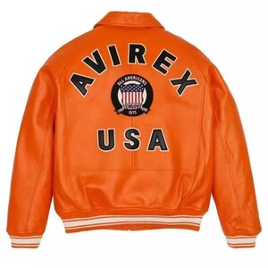 May include: Bright orange leather jacket with the word "AVIREX" across the shoulders and "USA" at the bottom. A circular patch in the centre features a shield with the American flag and the words "ALL AMERICANS ESTABLISHED 1975". The jacket has a ribbed white and black trim.