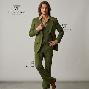 May include: A three-piece olive green suit with a notched lapel jacket, vest, and flared trousers. The suit is paired with a patterned button-down shirt and brown shoes. The logo "VINTAGE TUX RETRO STITCHED" is visible.