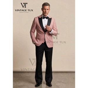 May include: A formal suit with a pink jacket, black lapels, and black pants. The jacket has a two-button closure and a black bow tie. The suit is from Vintage Tux.